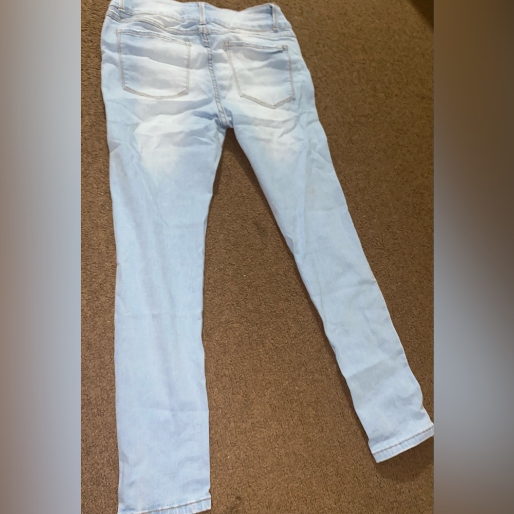 Light blue jeans,brand new,ripped a little that how the style is